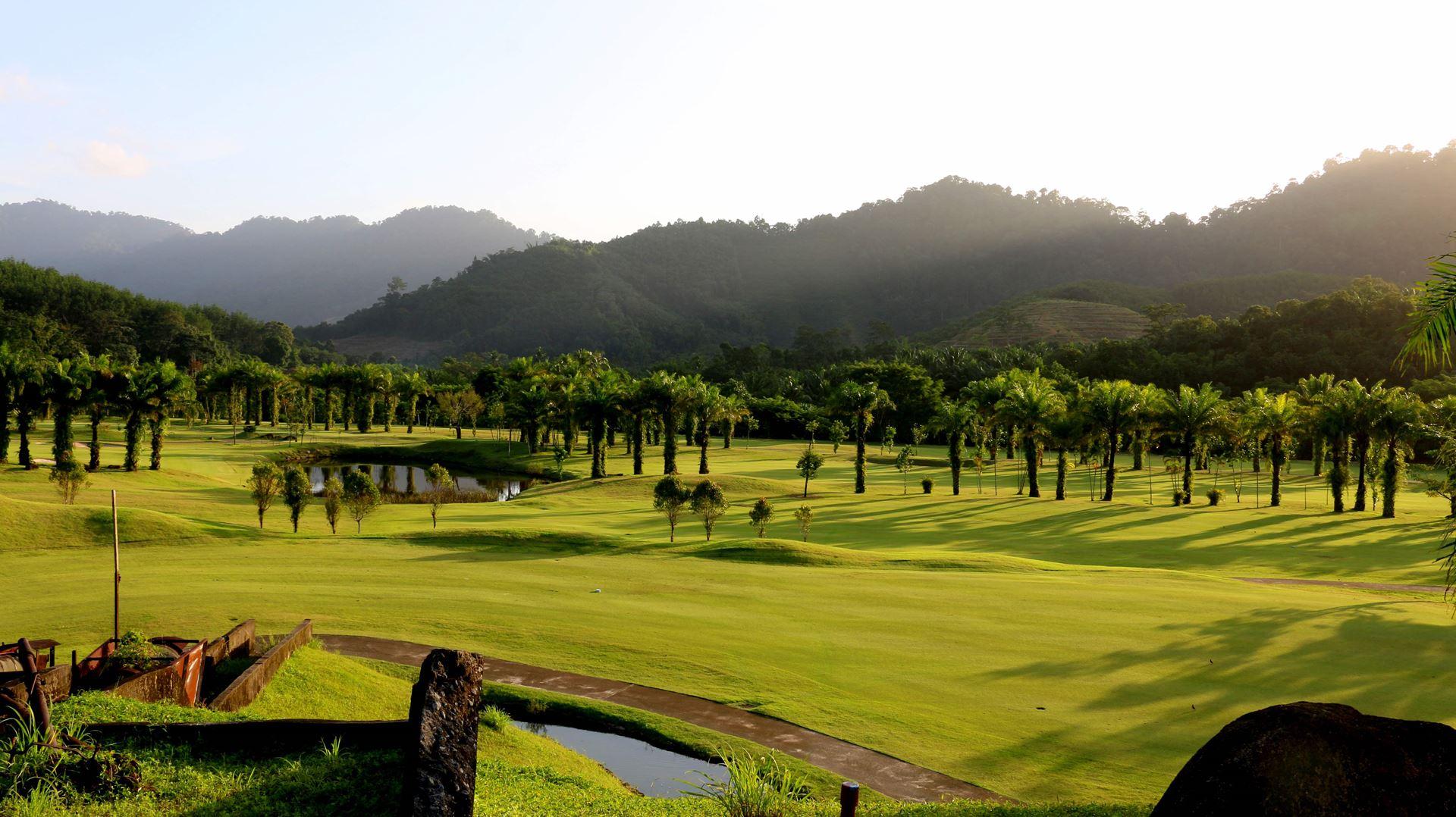 The well maintained Palm Hills under the sun framed by mountains