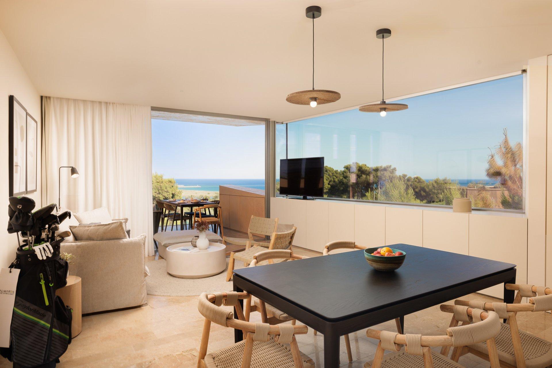 Living and dining room area with a balcony