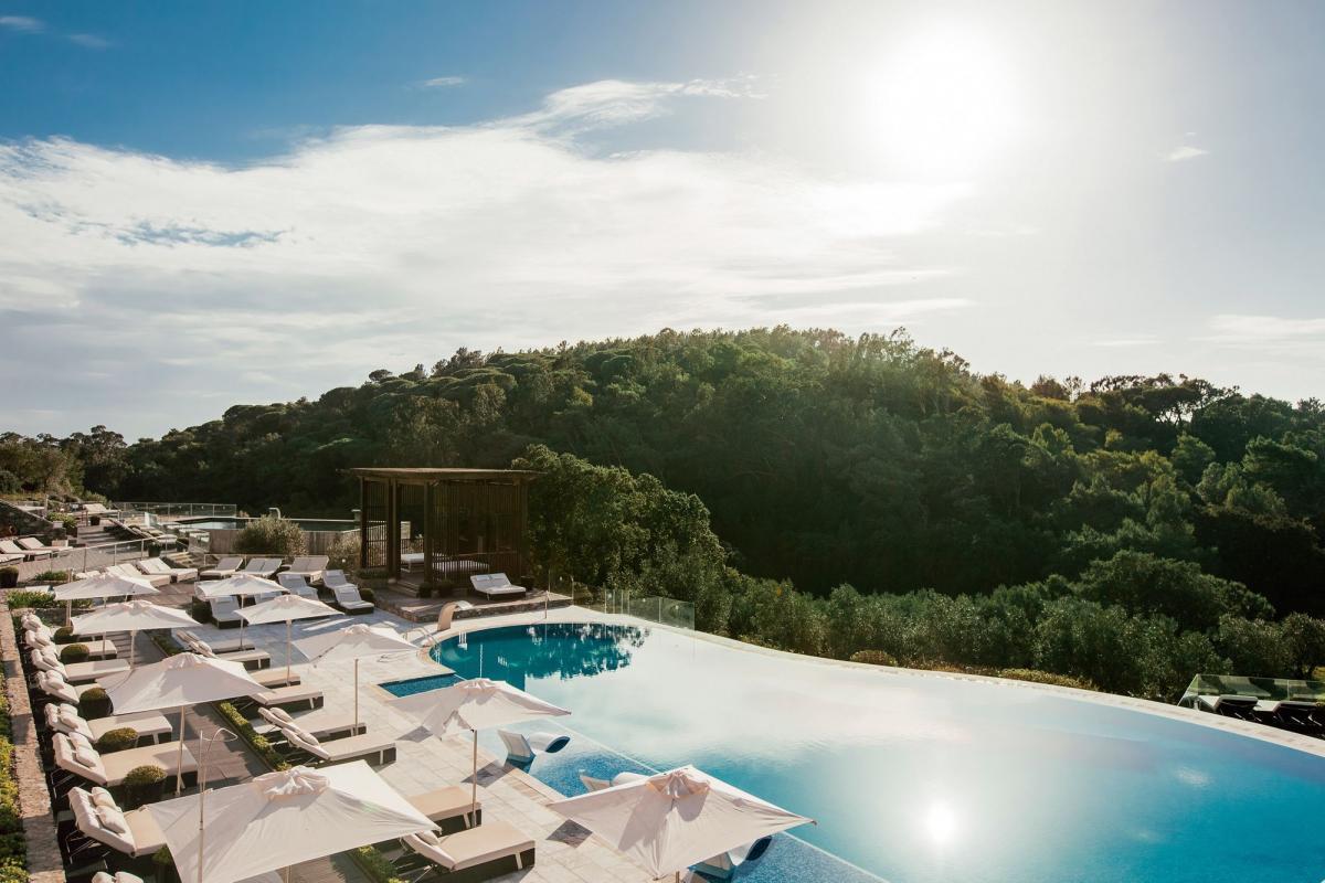Outdoor swimming pool and lounge area with views across the area