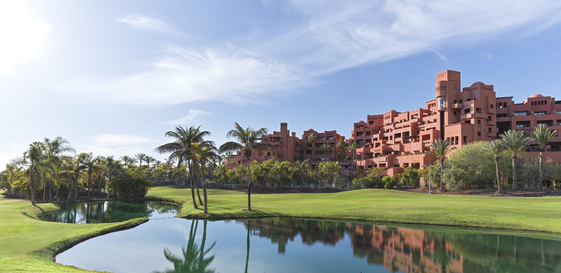 View of a narrow fairway with a water hazard on one side and the resort on the other