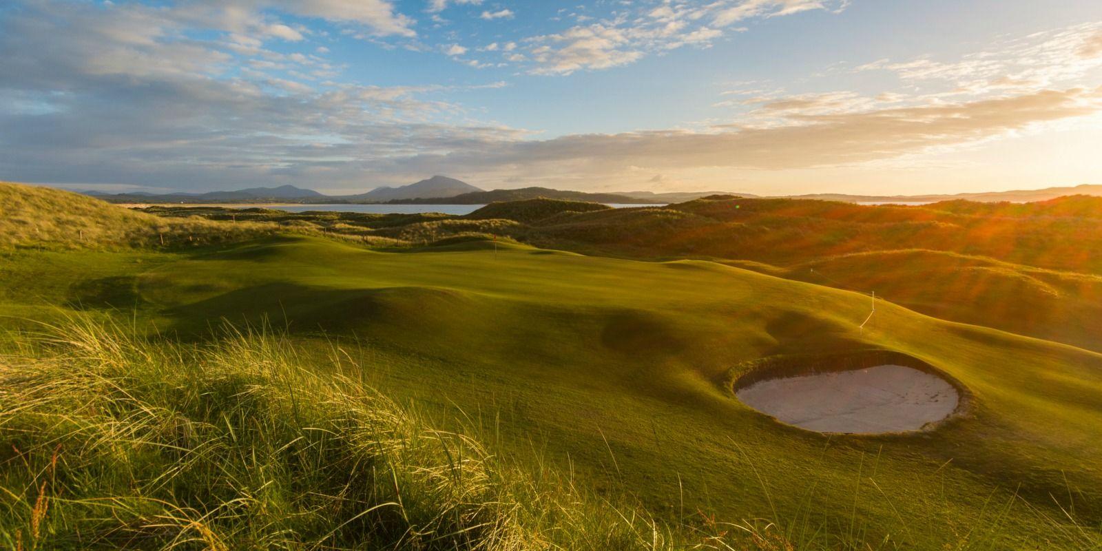 Lovely view of the greens with a bunker under the sunset