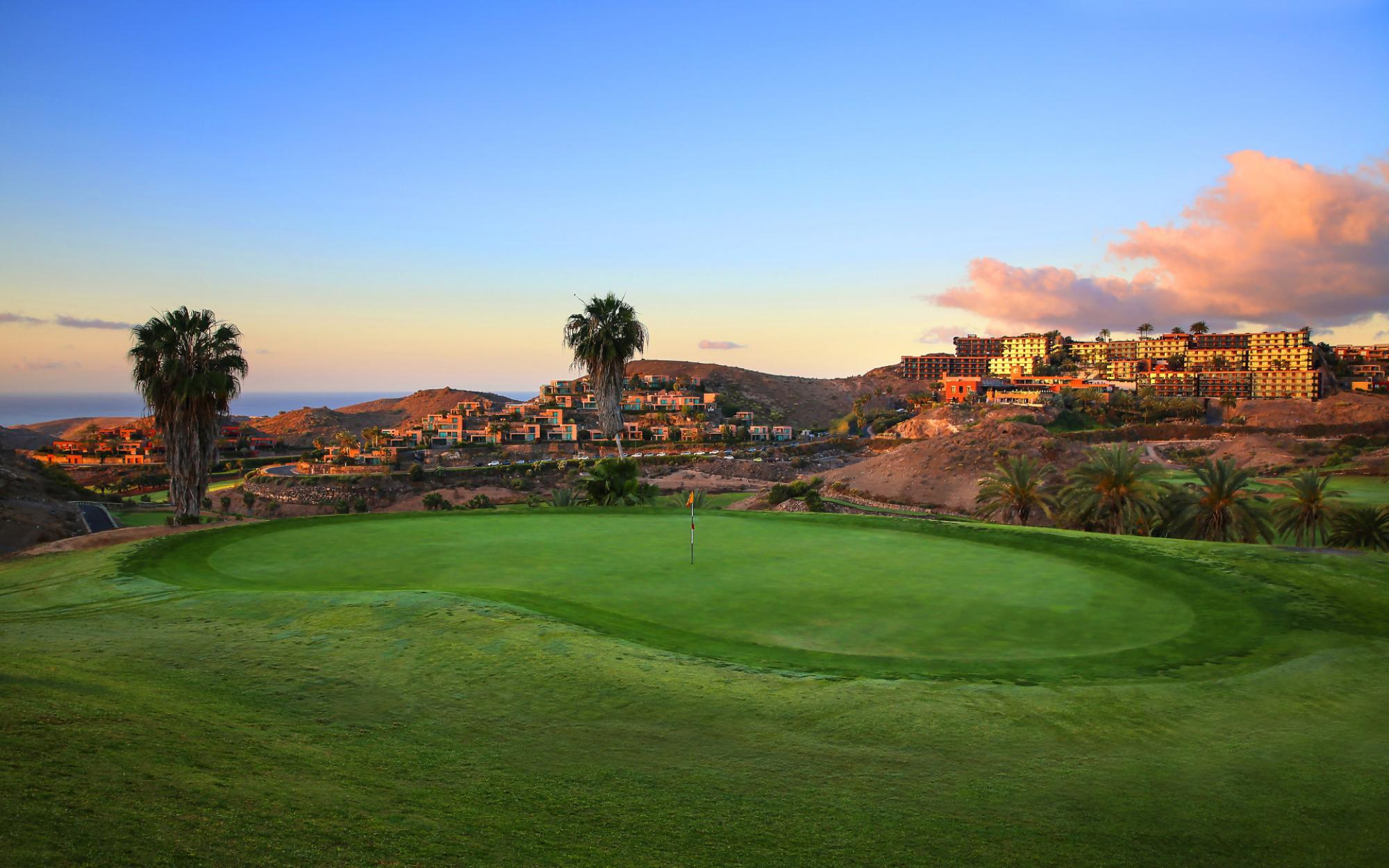 Green with a view of the Salobre Hotel Resort & Serenity behind it