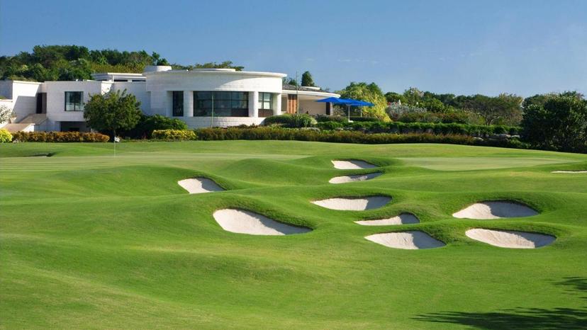 A striking view of the course with cliffside terrain and water hazards creating a visually dramatic and challenging layout.