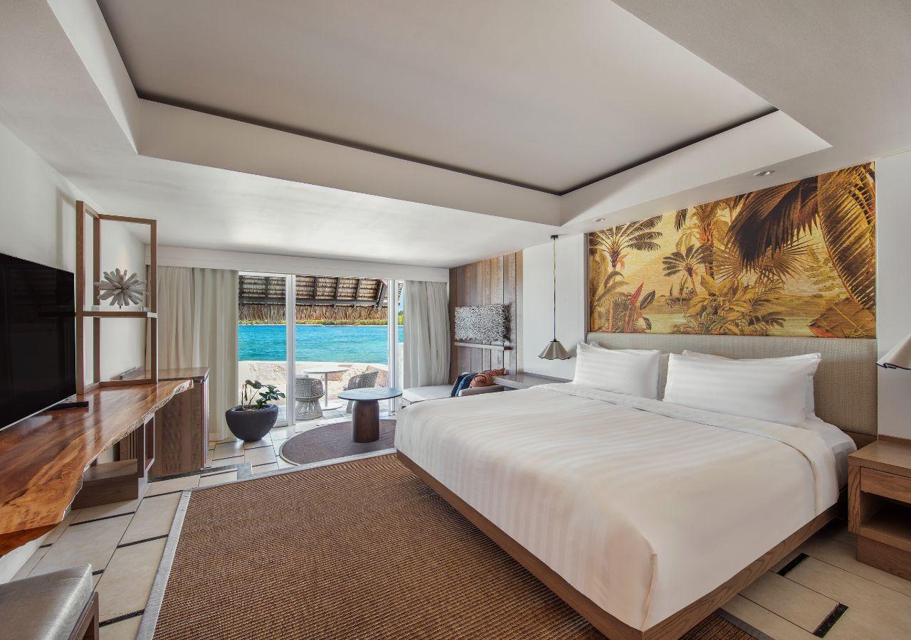 A modern double bed room with balcony views of the ocean
