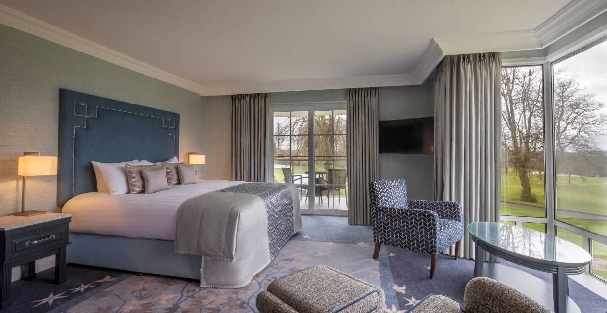 A lovely modern bedroom at the Slieve Russell with a grey theme and beautiful view & balcony overlooking the greens