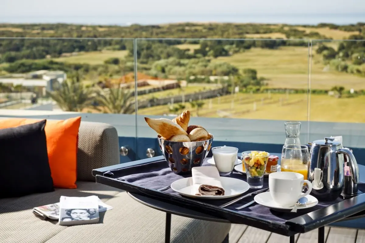 Balcony with a table spread with breakfast and landscape views