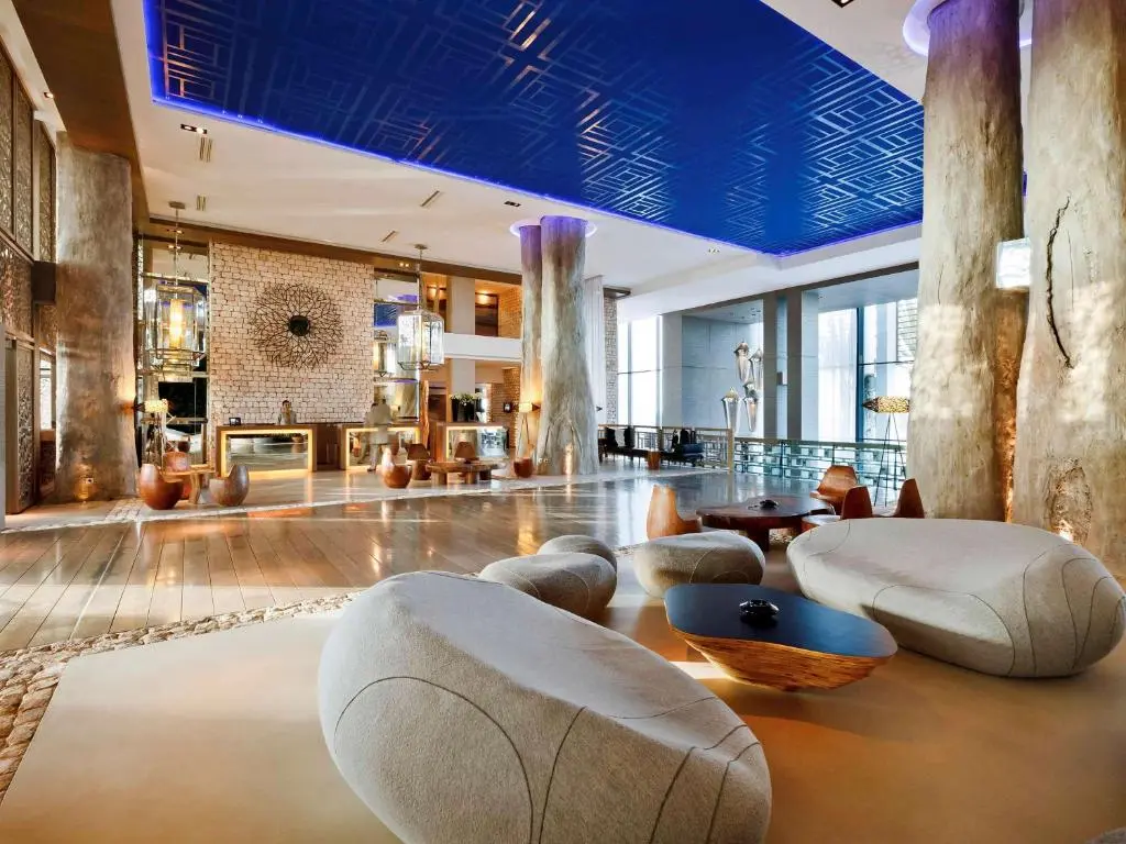 Reception at the hotel with natural tree like pillars around the seating areas