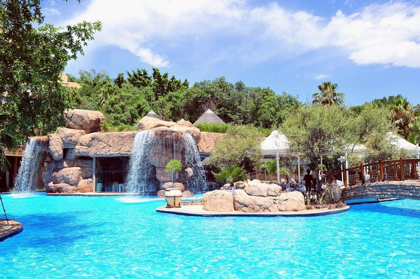 Swimming pool at the hotel with a rock water fountain