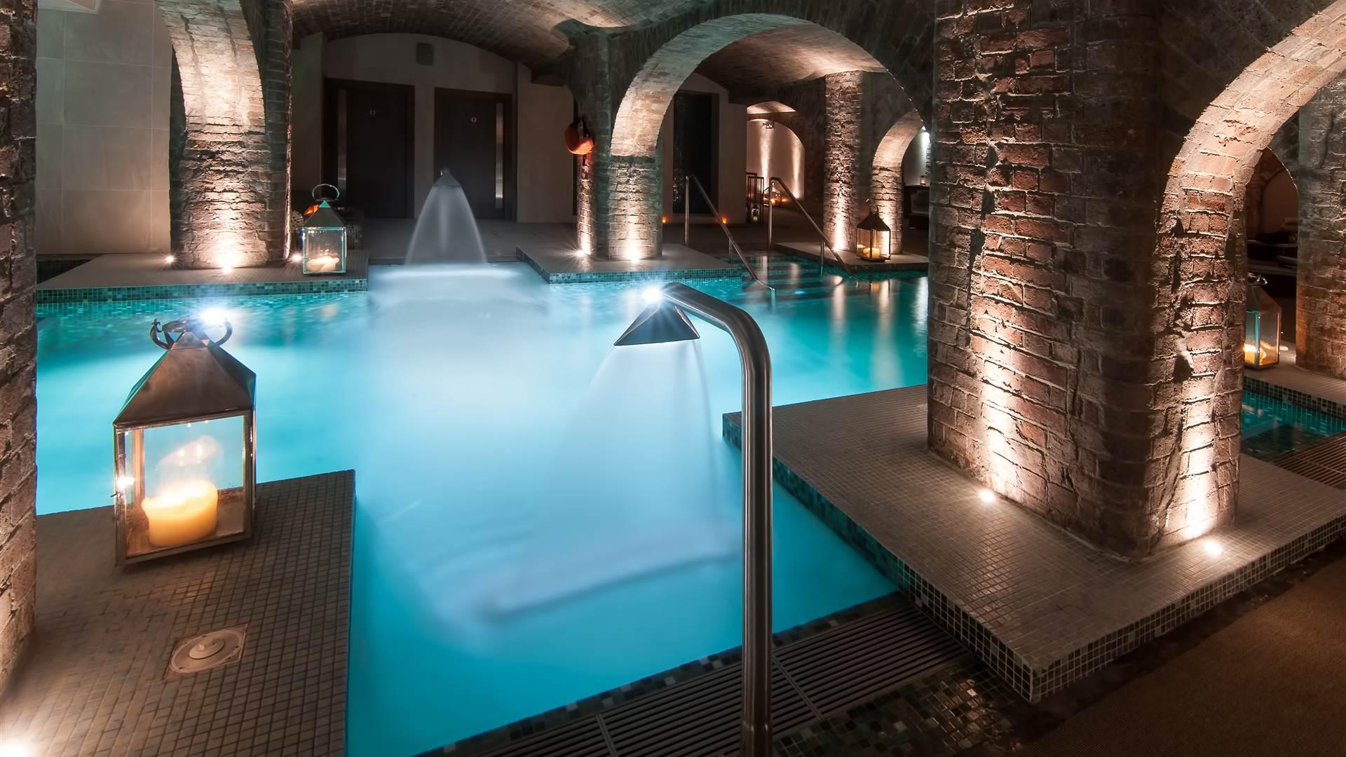 Indoor swimming pool at the hotel following the same stone brick design throughout the building