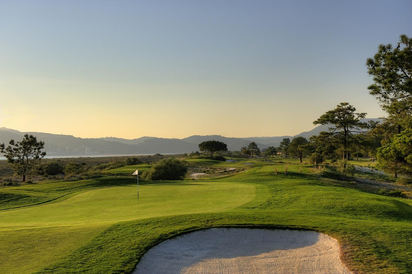 Narrow fairway leading to an undulating green