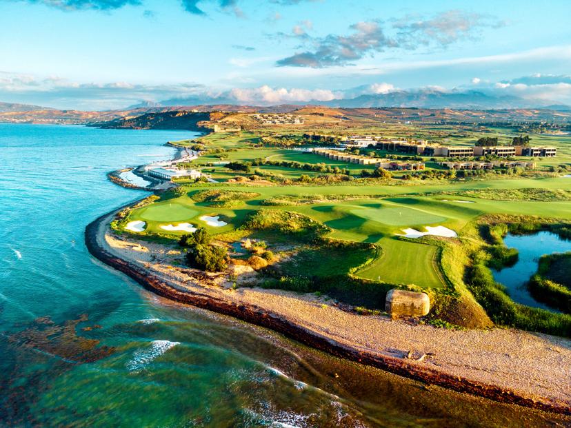 Overhead view of The Verdura Links with smooth greens, sand bunkers, and coastal views