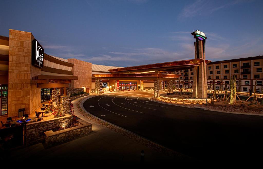 Front entrance to the resort under evening skies being illuminated by the buildings lights