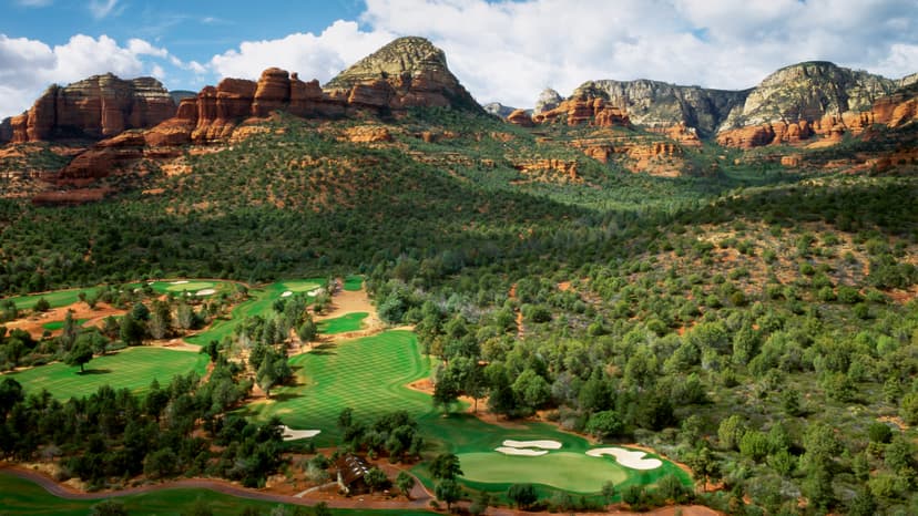 Aerial view of the Sedona Golf Club course with its rough nestled with trees and mountainous views