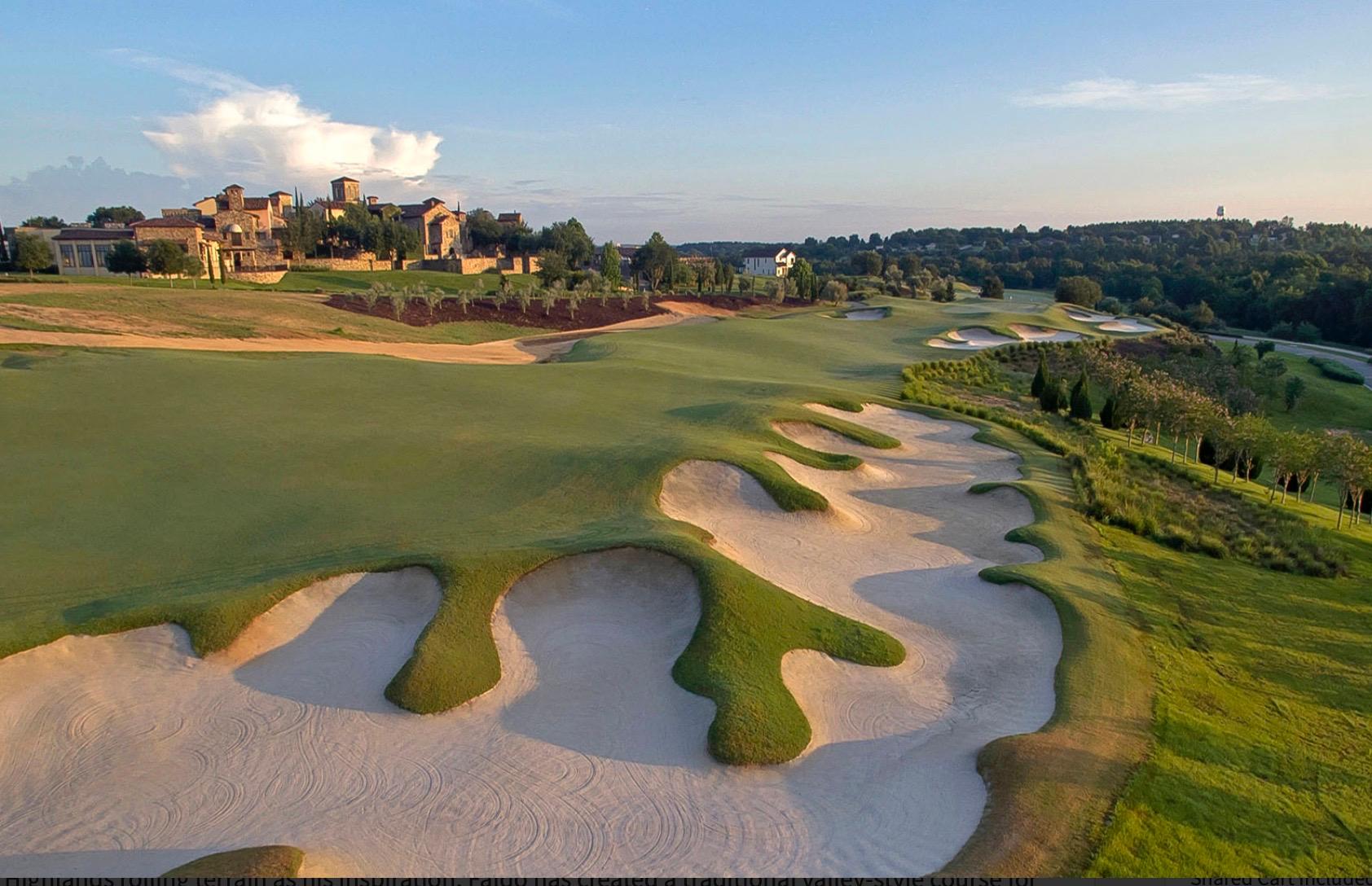 Overhead view of a large sand bunker places along a winding fairway