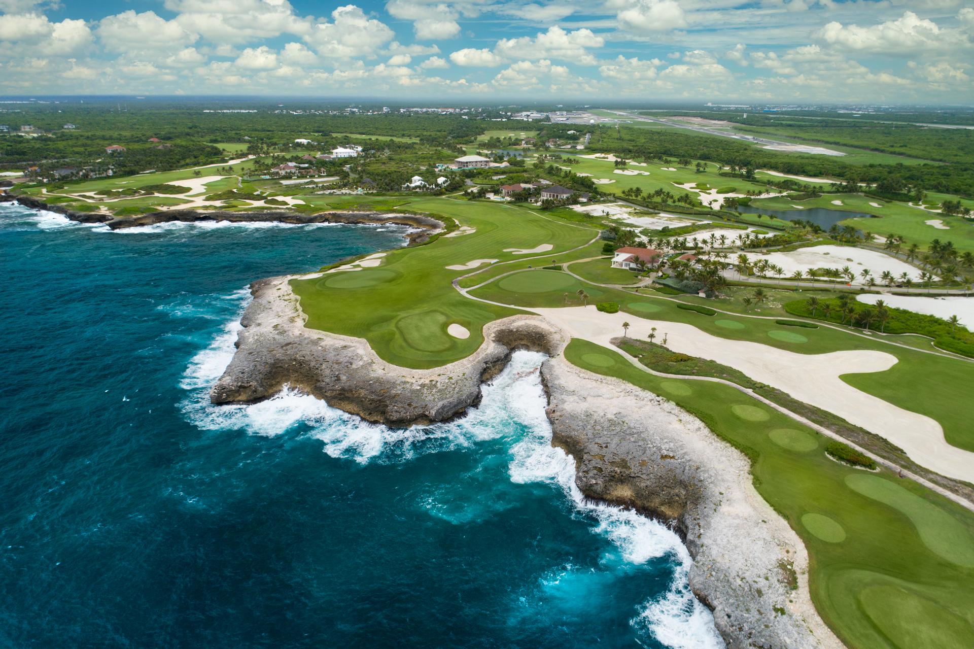 Overhead view of manicured green and well maintained fairways on the course