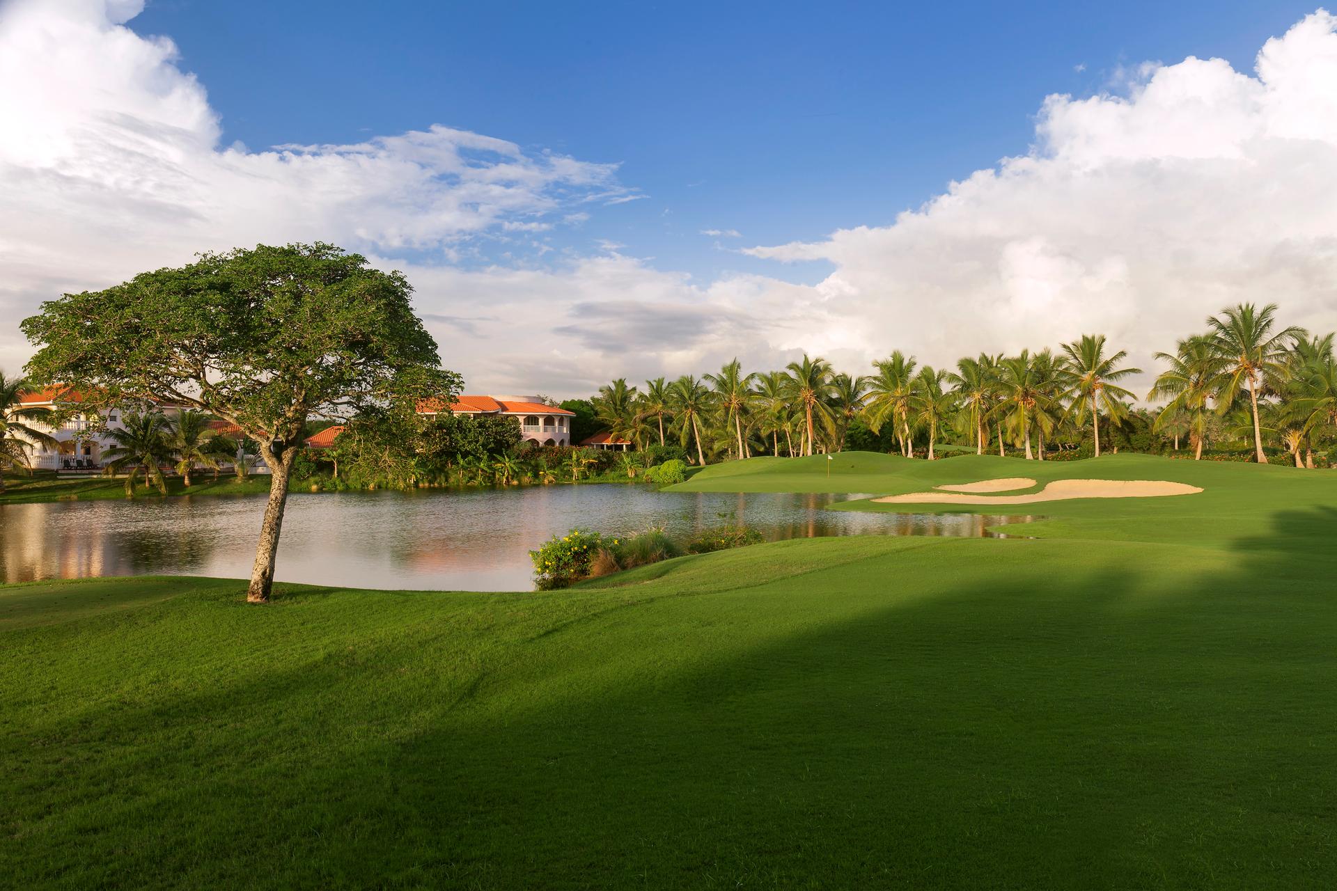 A winding fairway running along a water hazard leading to a smooth green
