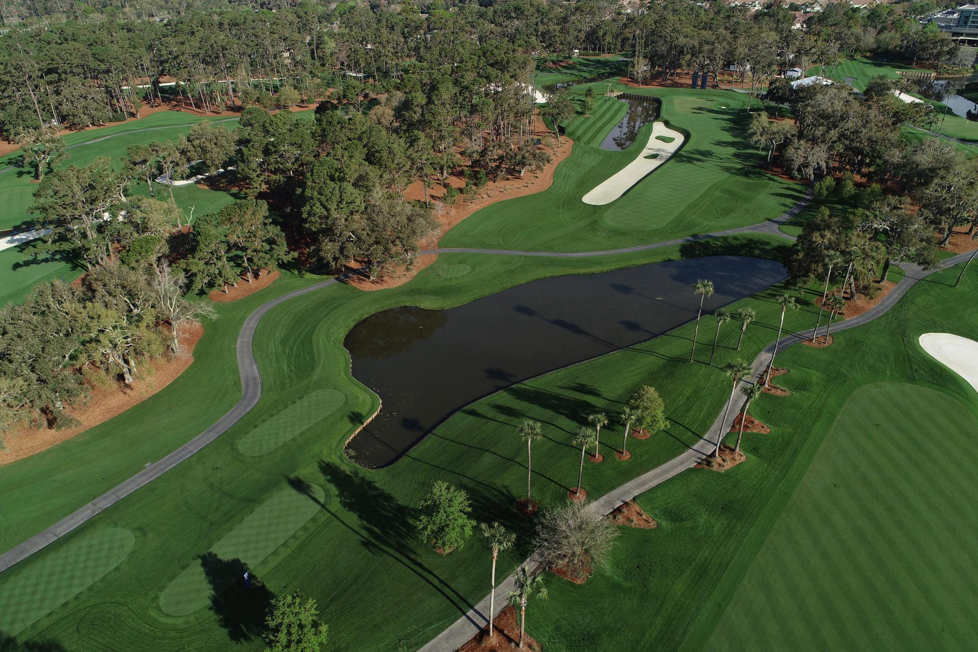Overhead view of smooth green well maintained fairways and pristine water hazards on the course