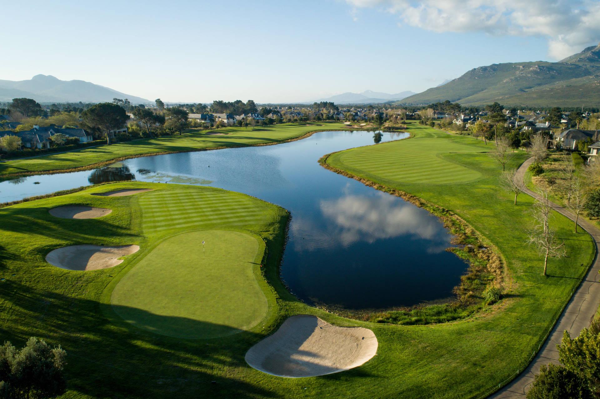 Aerial view of Pearl Valley Golf Club with a large water hazard in front of a green