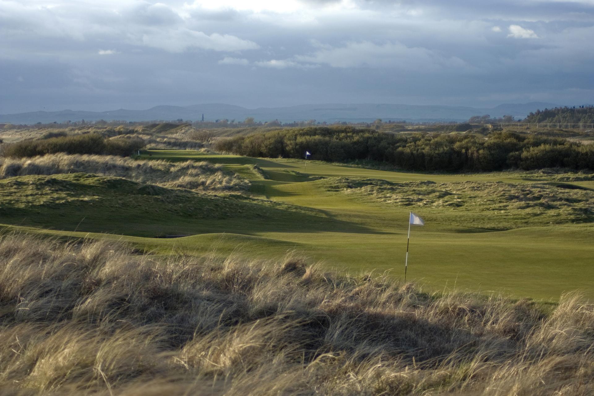 Undulating green surrounded by thick rough at Prestwick Golf Club