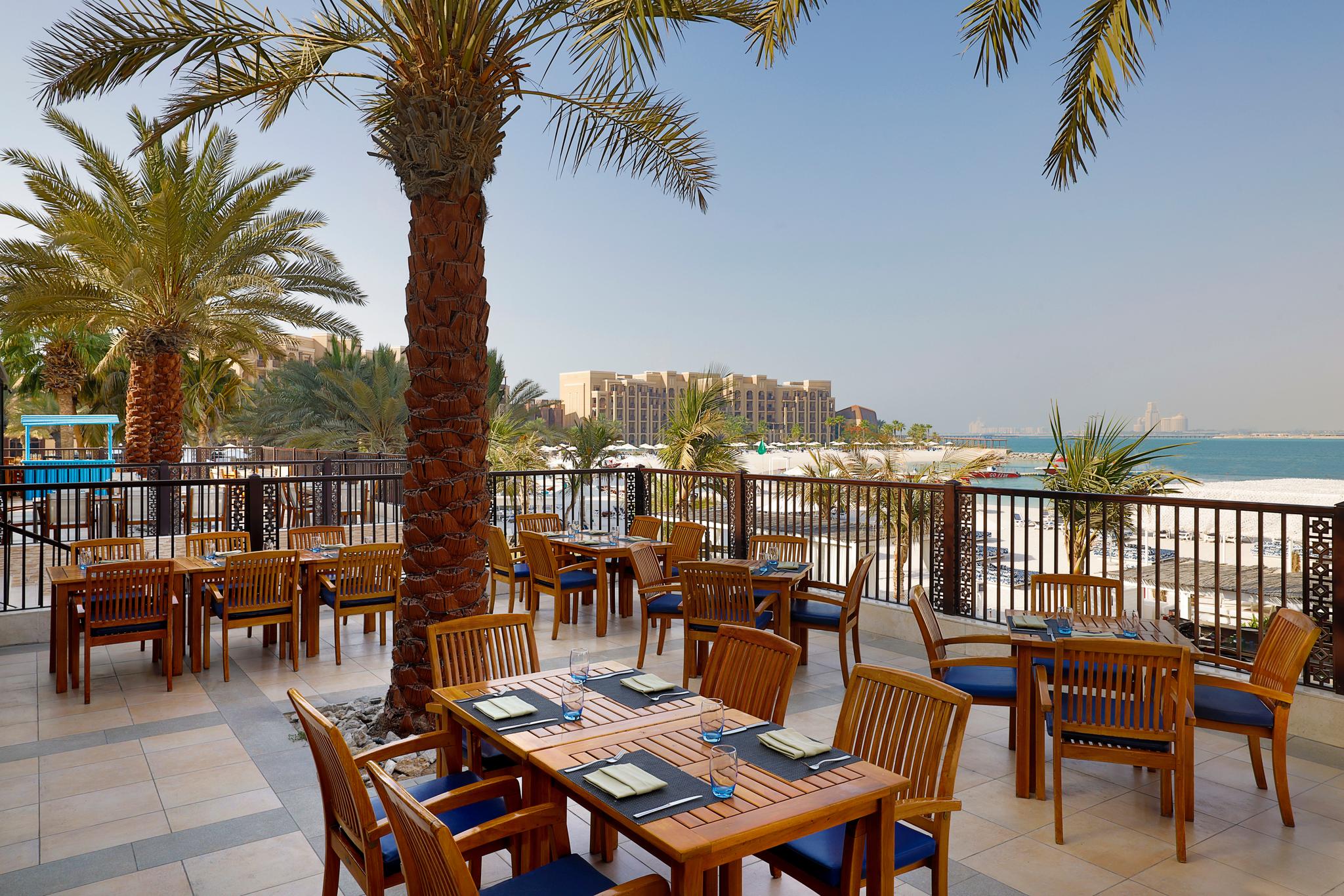 Outdoor dining area with beach and sea views