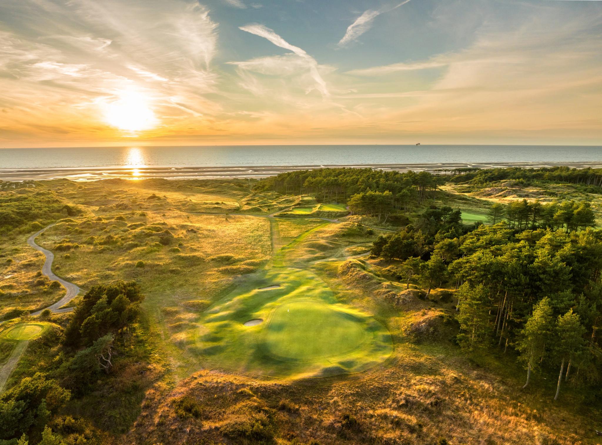 Overhead view of the sun shining over the course