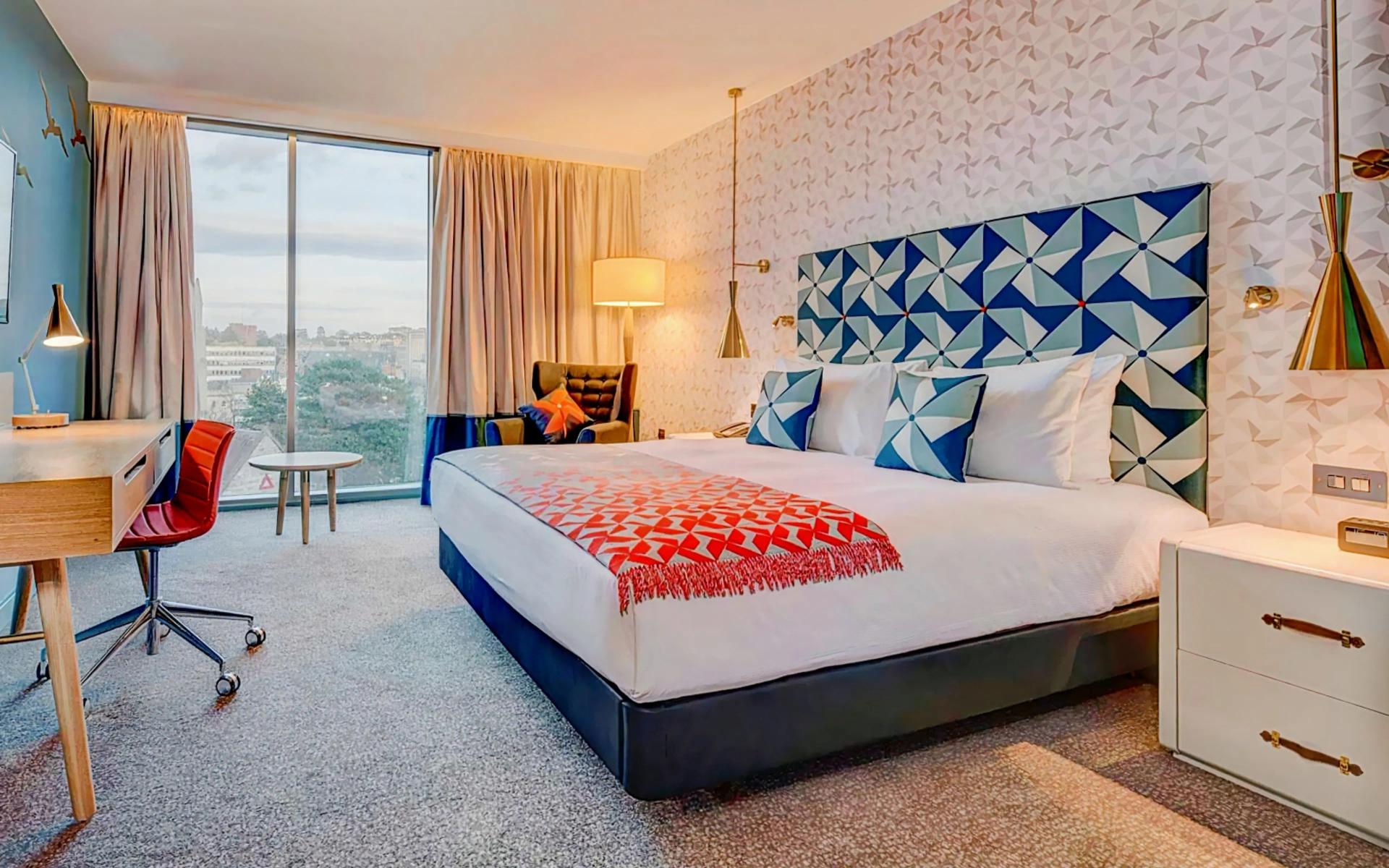 Double bed room with window views of the city