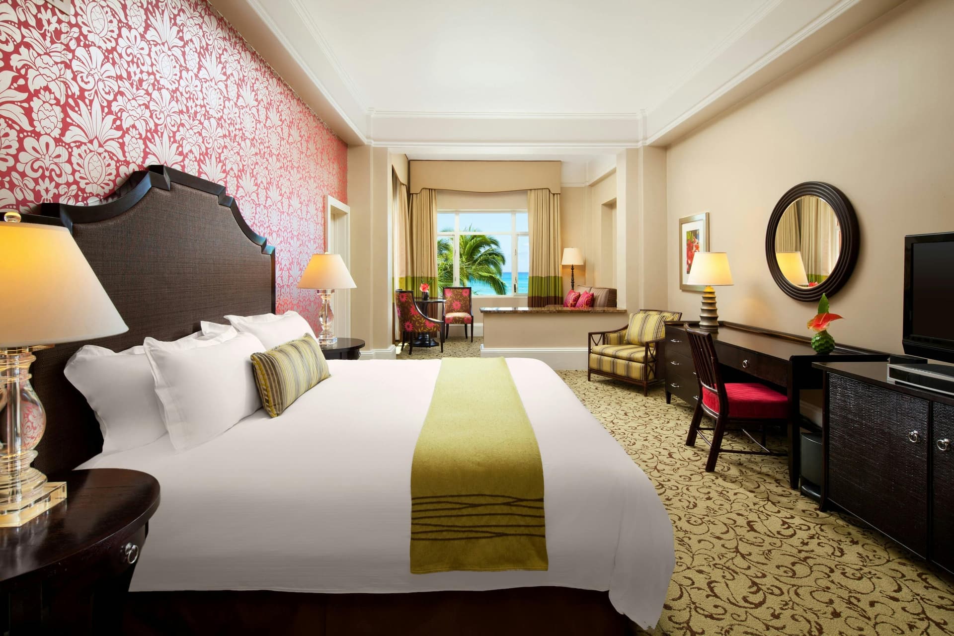 Spacious double bed room with a red wallpaper design