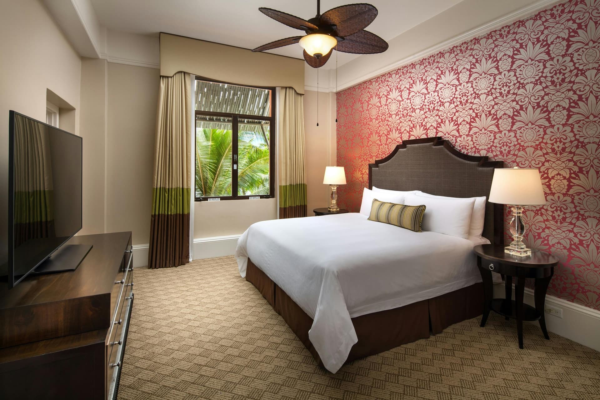 A modern double bed room with a smart television