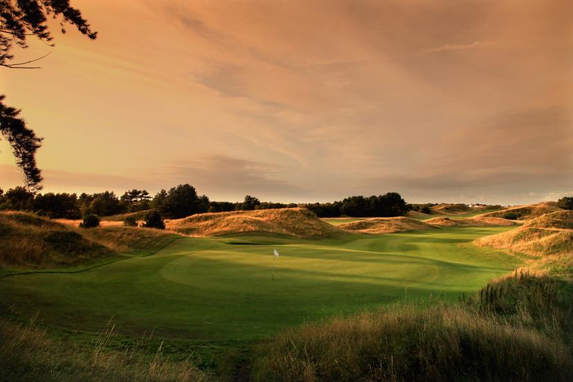Well maintained fairway leading to a smooth green at sunset