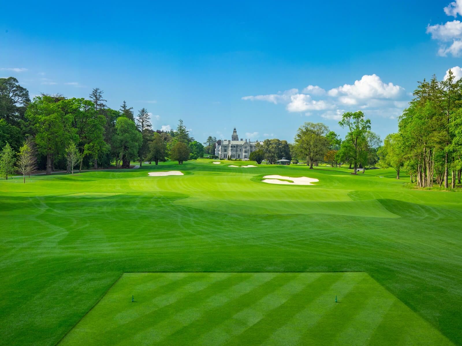 Tee box leading towards a well maintained fairway nestled with sand bunkers