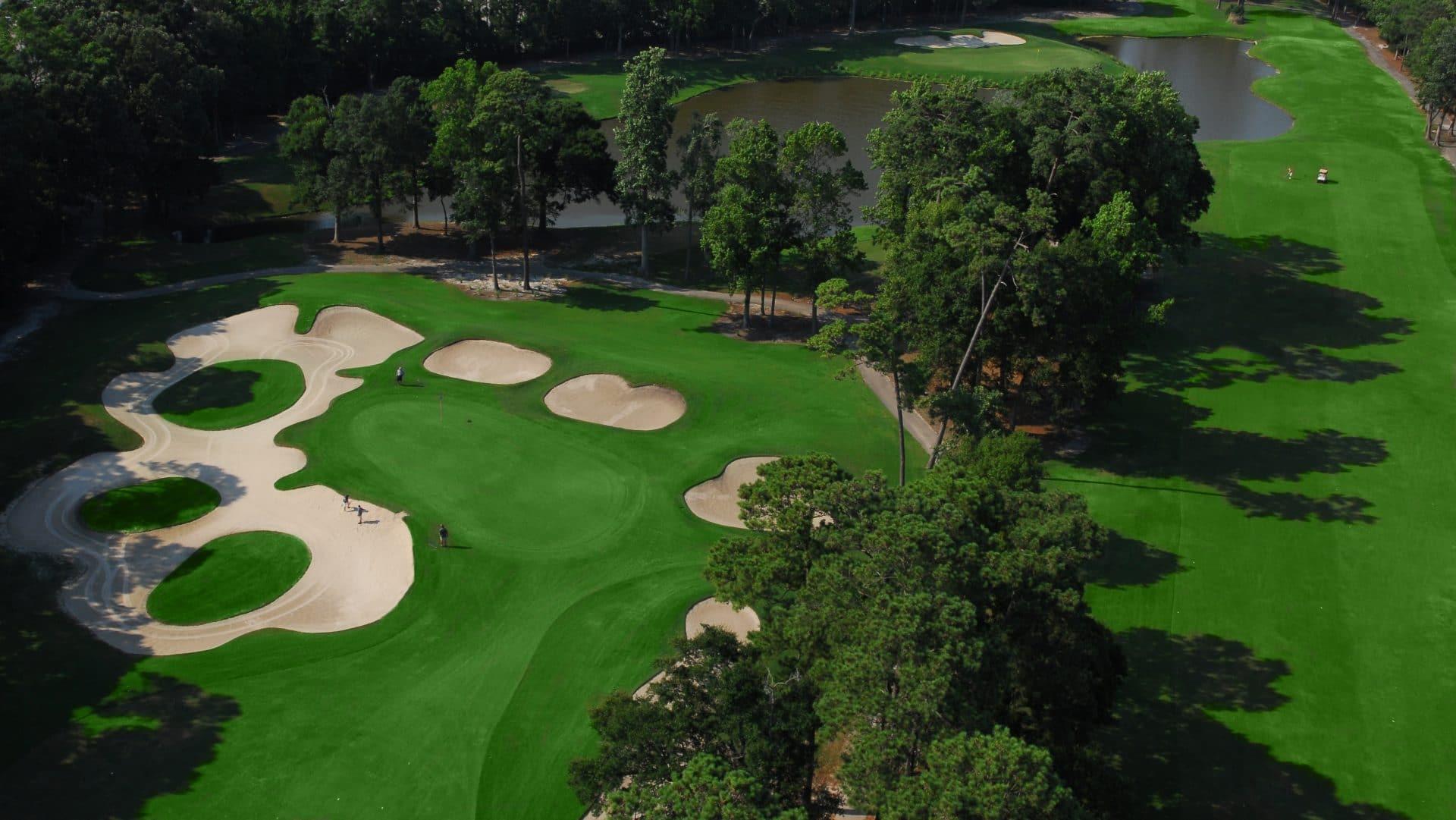 Overhead view of a smooth green surrounded by sand bunkers
