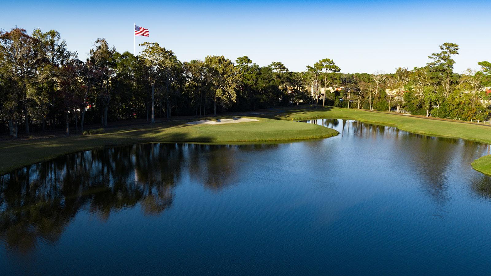 A large water hazard next to a smooth green