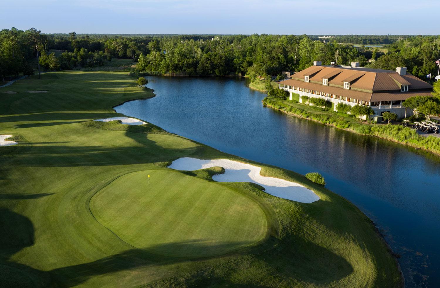 A sand bunker sandwiched between a smooth green and a water hazard