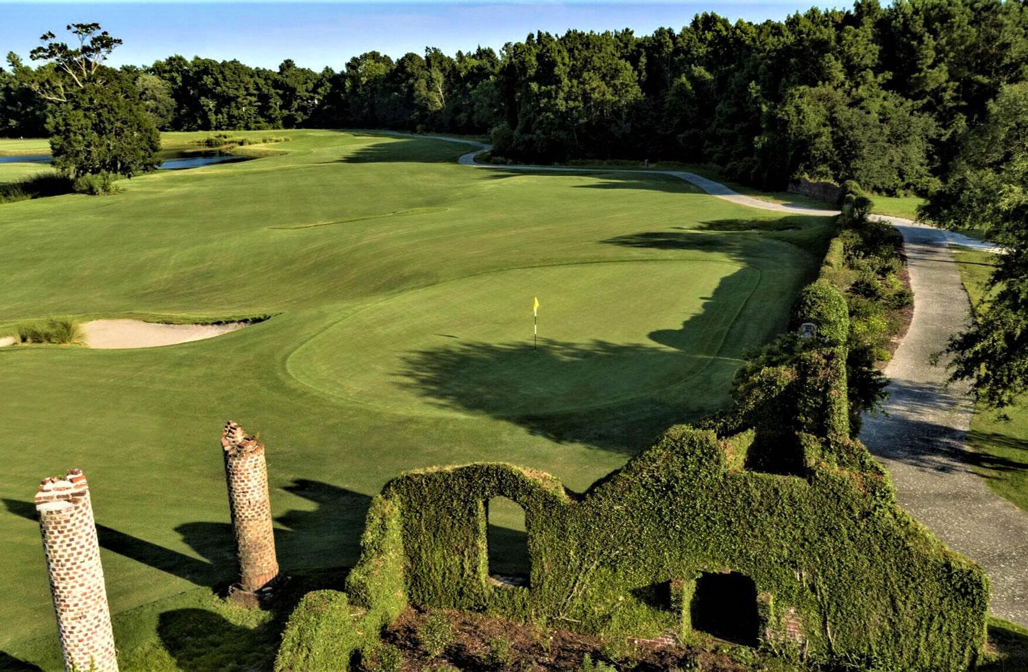 Overhead view of a wide fairway surrounded by a tree line