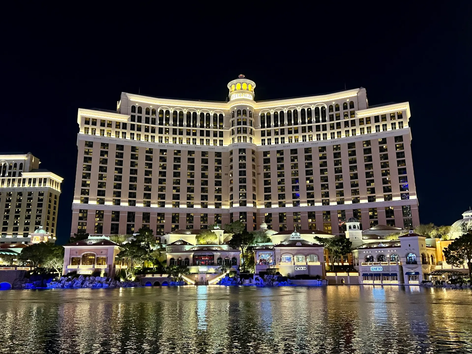 Night view of the illuminated Bellagio Hotel reflecting on the water.