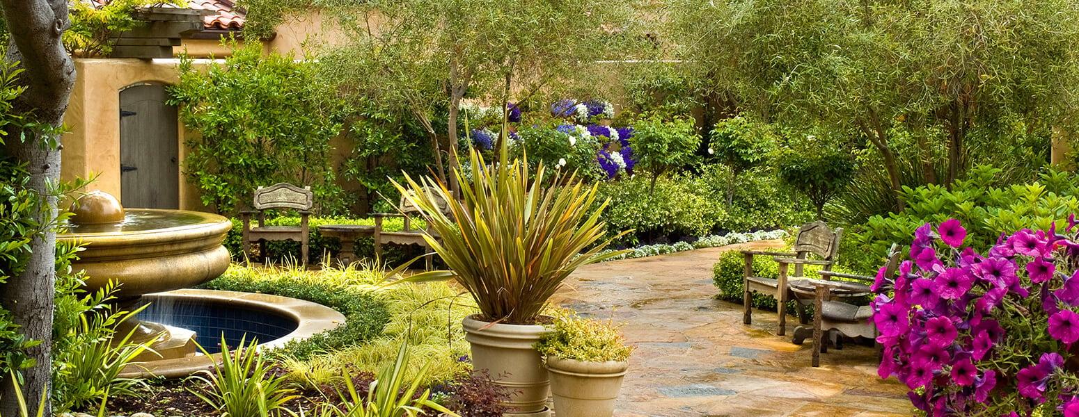Casa Palmero's garden featuring a water fountain, vibrant flowers and seating to soak it all in