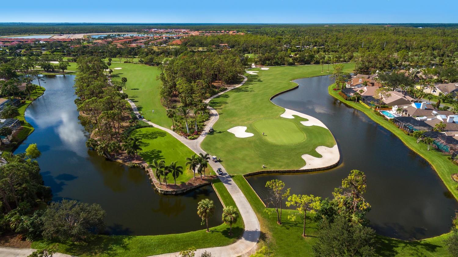 Birdseye view of a river running through the Eagle creek course separating it from local houses
