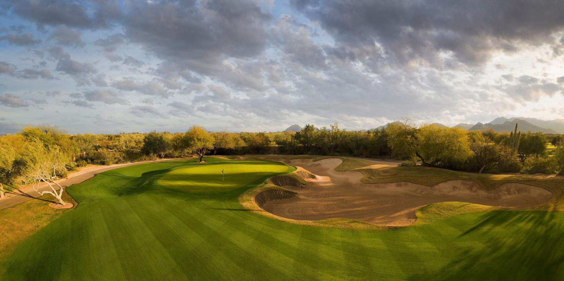 Extra Large uniquely shaped sand bunker next to an elevated green