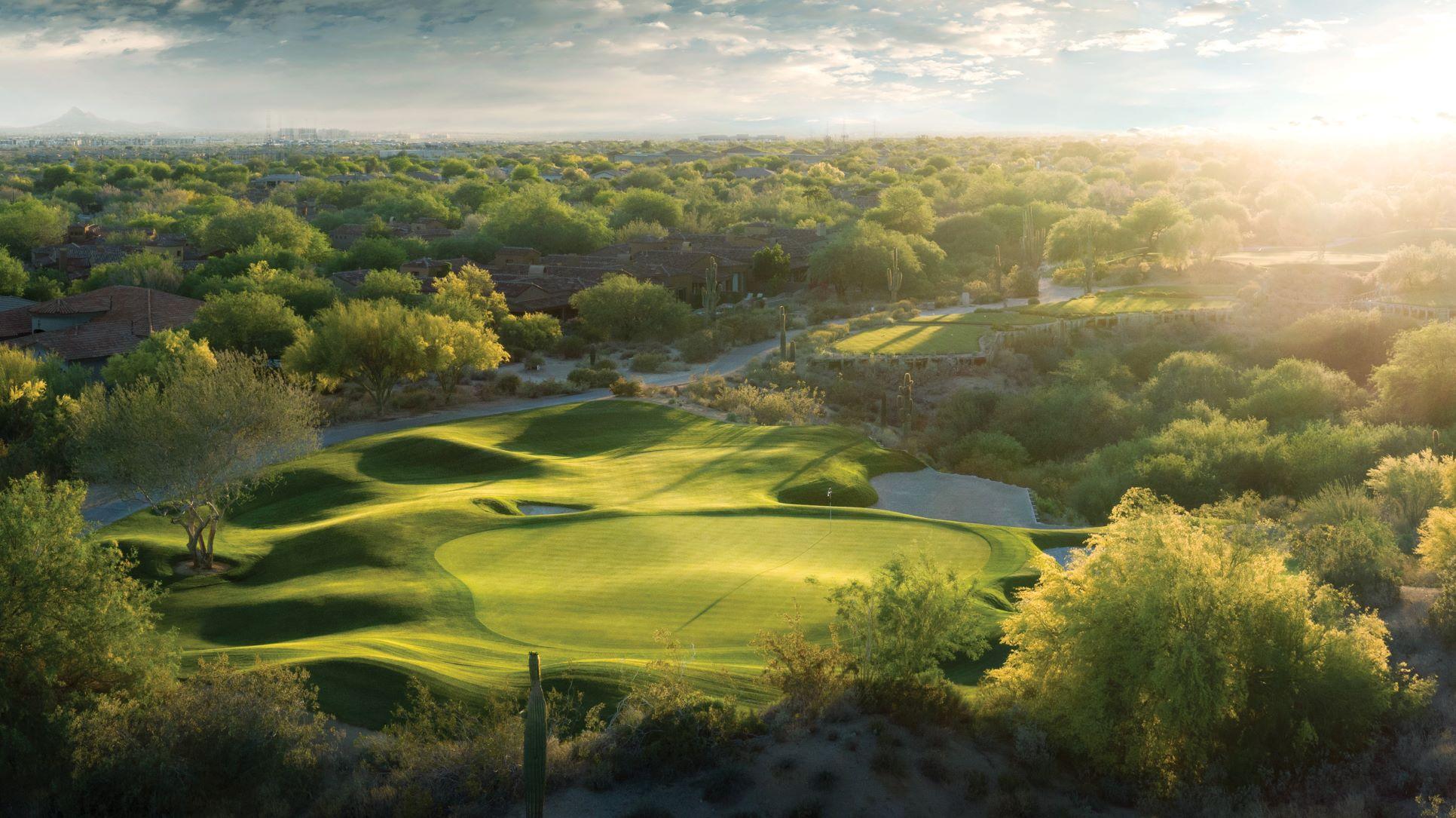 Aerial view of the sun setting over a manicured green at the Grayhawk Talon Course