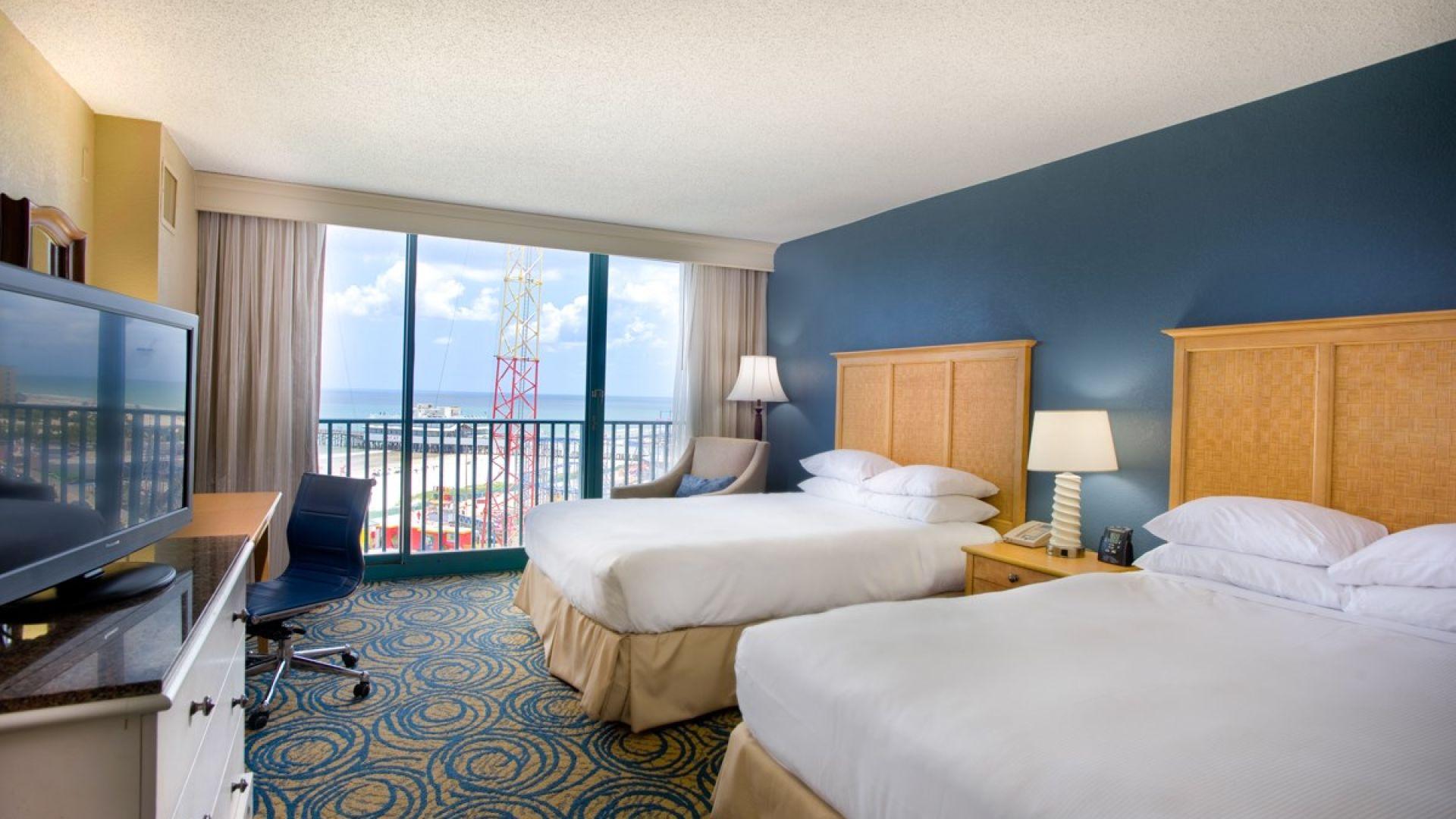 Twin double bed room with balcony views of the beach