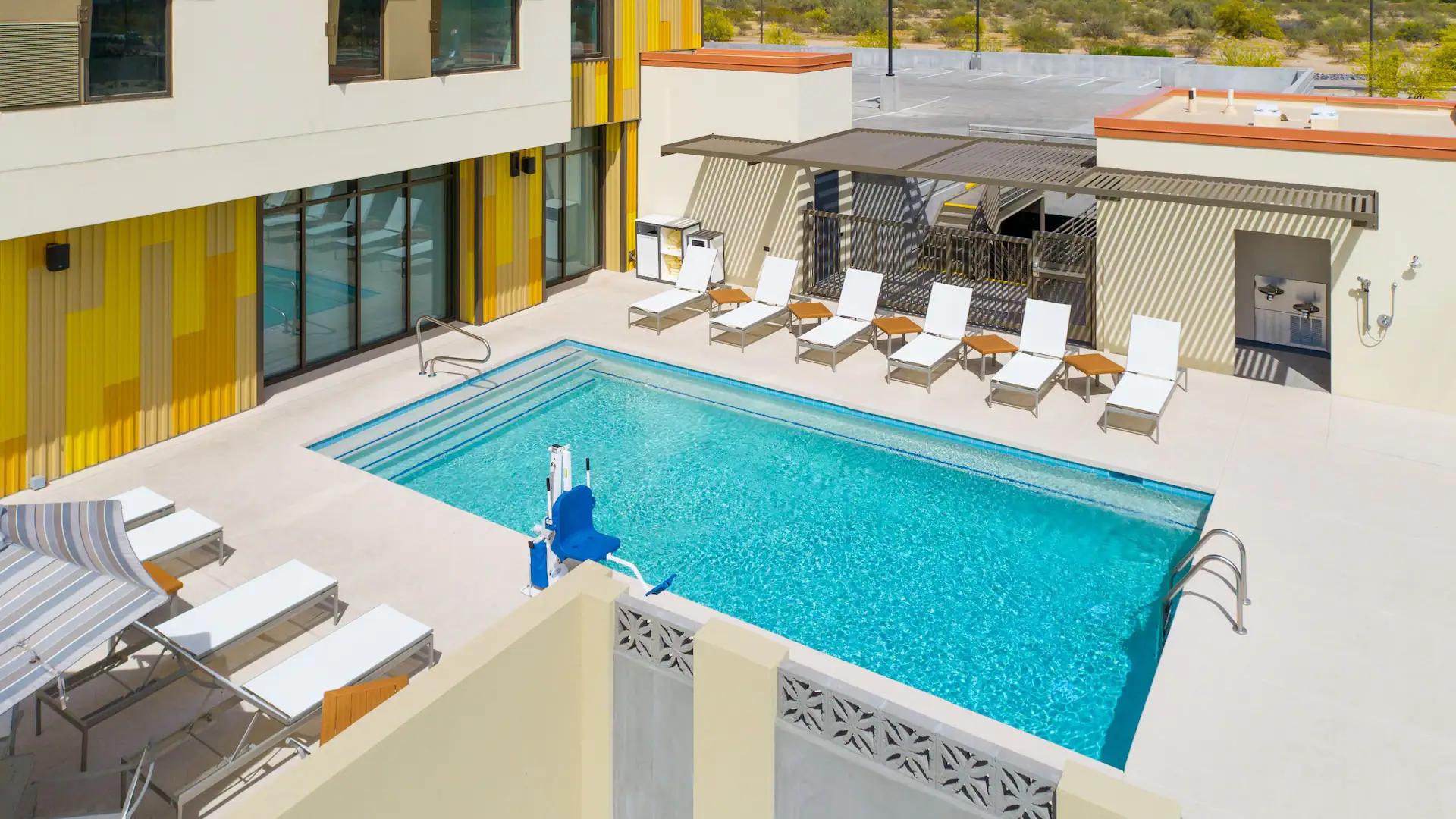 Outdoor swimming pool with sunbeds at the Hyatt House North Scottdale