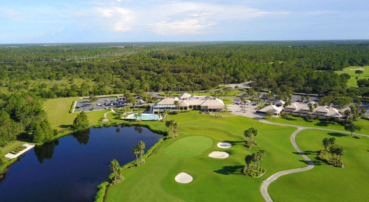 A stunning aerial view of LPGA International Hills showcasing the lush fairways, greens, and surrounding forest.