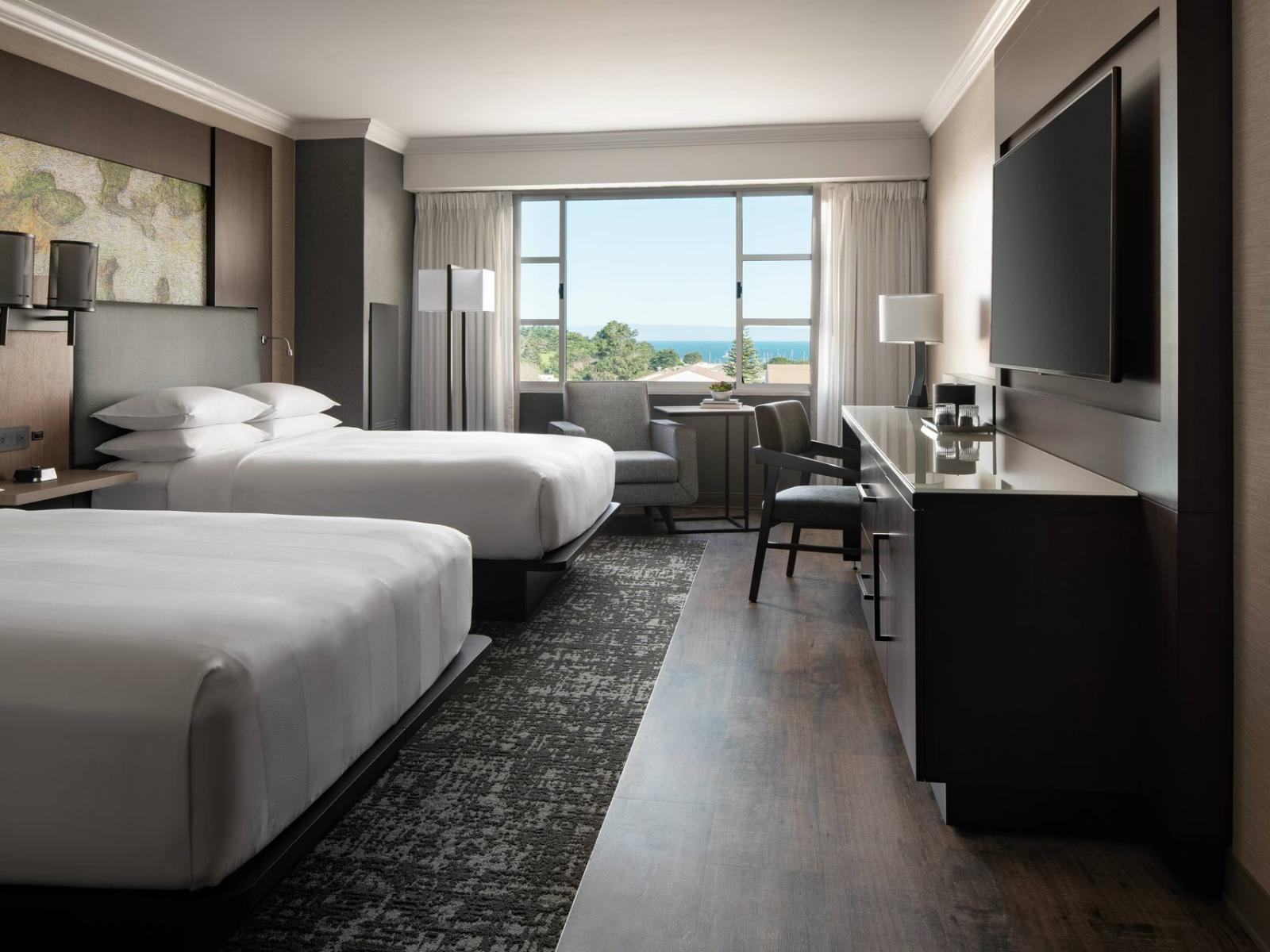 Twin double bed room at the hotel following a ,modern grey design