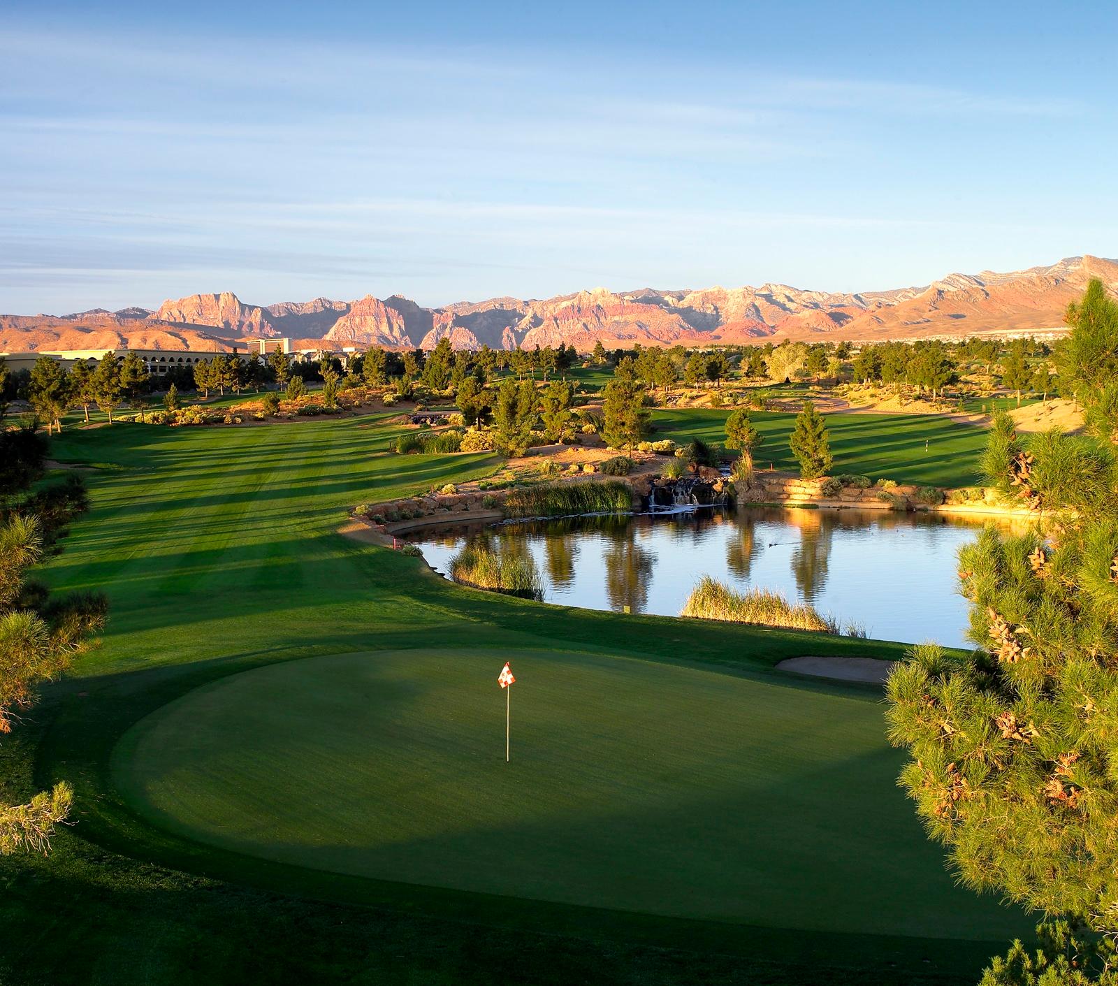 A wide well maintained fairway leading to a smooth green strategically placed next to a water feature on the mountain course