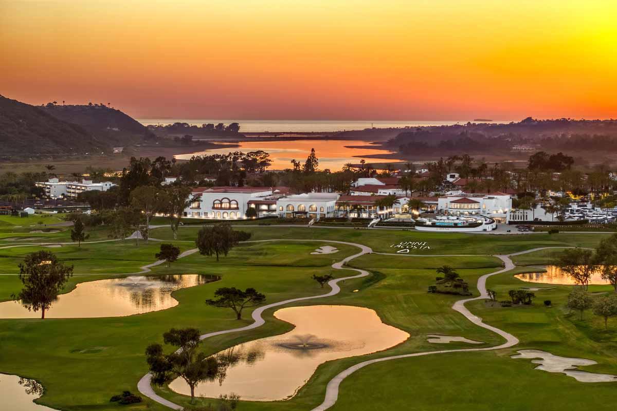 Sun setting over the course and resort causing their water hazards to reflect the sky