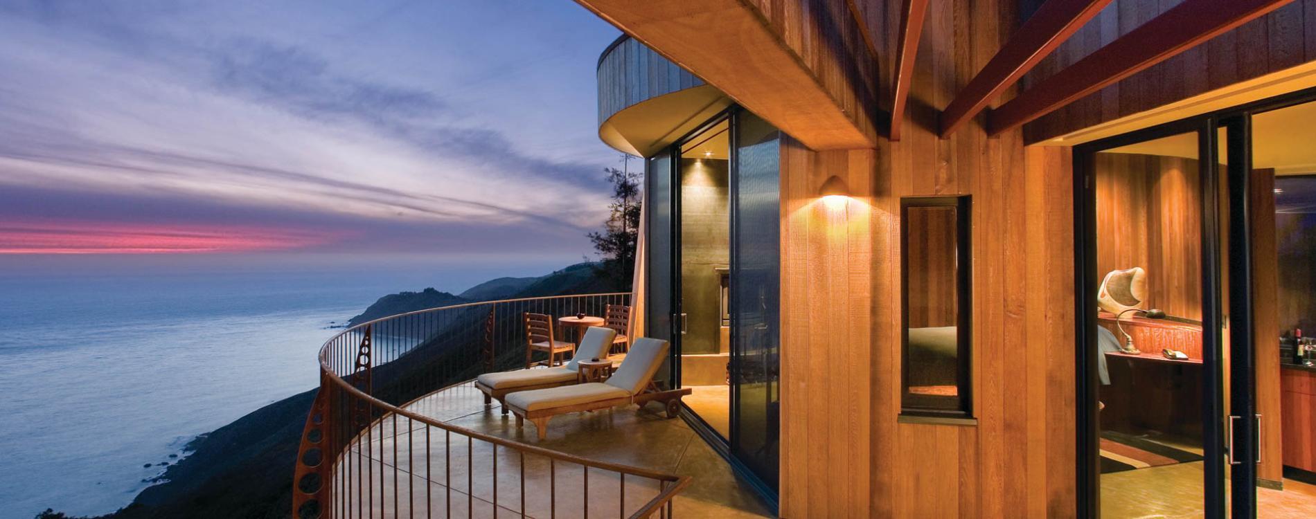 Hillside hotel with views of the ocean and sunbeds on the balcony