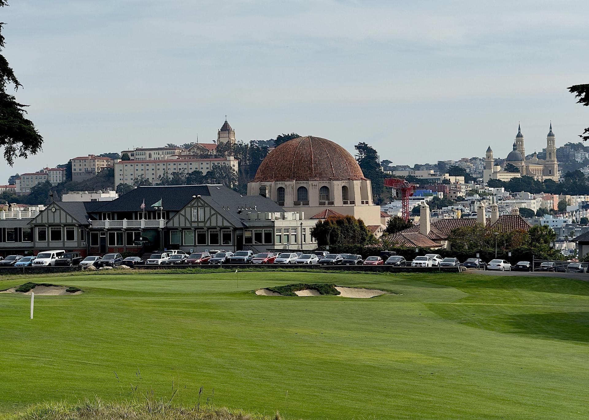 well maintained fairway leading towards a clubhouse