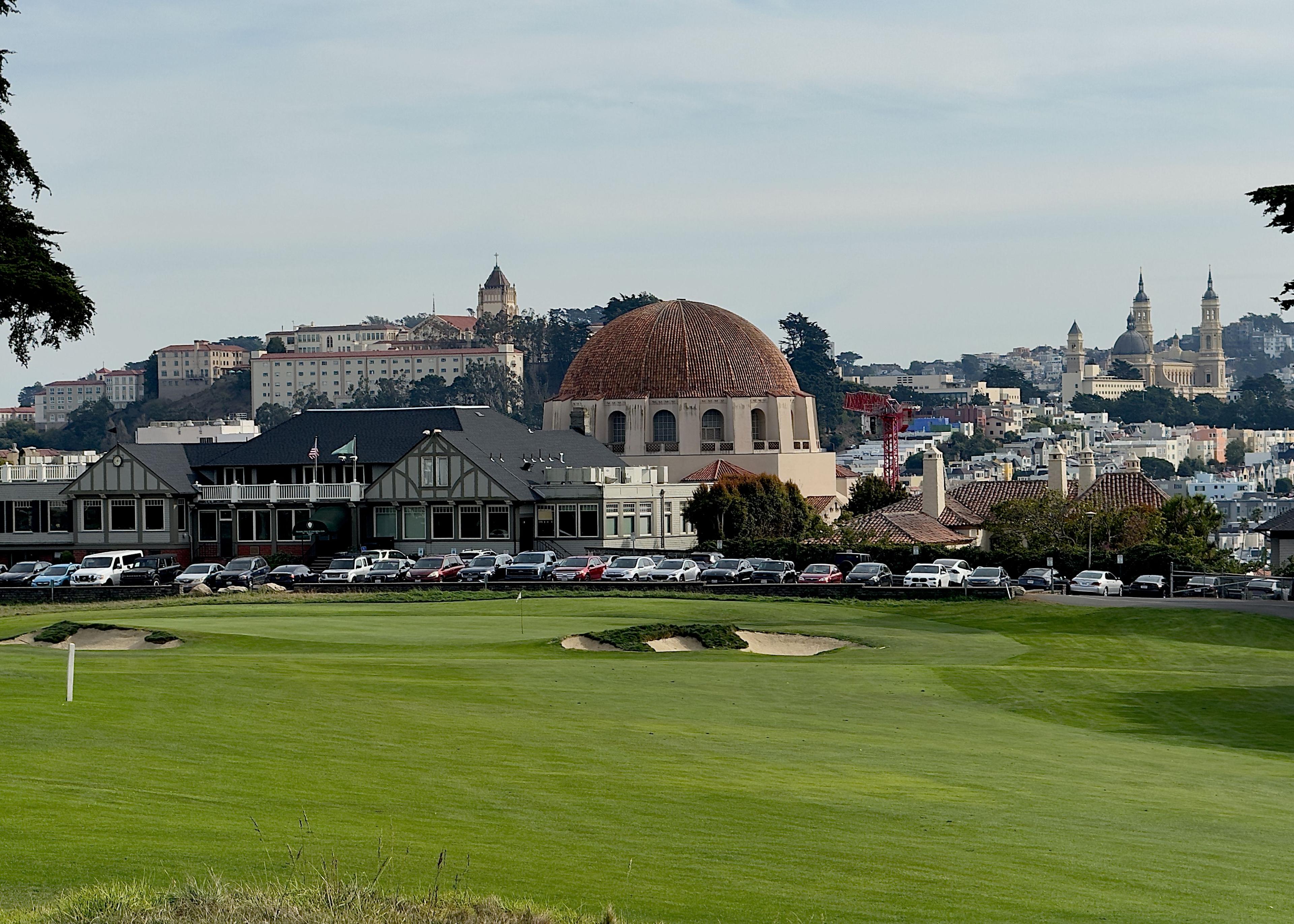 well maintained fairway leading towards a clubhouse
