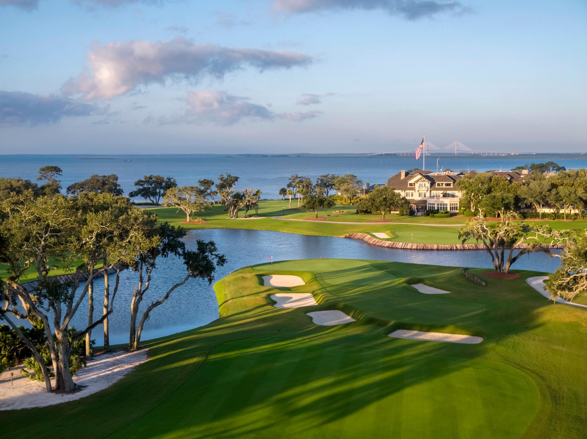 Overhead view of the seaside clubhouse overlooking the course with a grand bridge in the distance