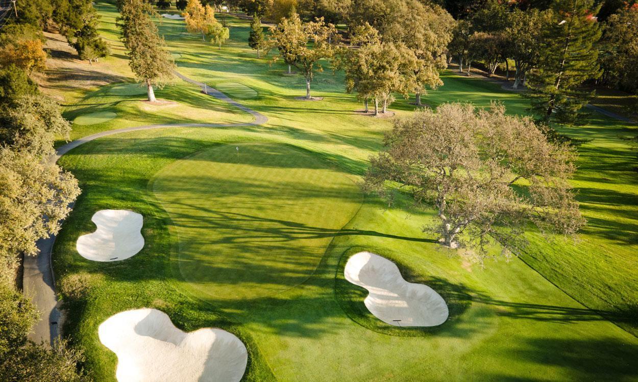 Overhead view of a smooth green surrounded by sand bunkers